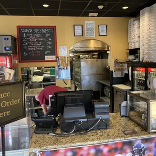 a restaurant counter with a pizza oven