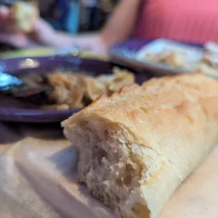 The signature fresh bread with 4 hour roasted garlic bulb, balsamic, and olive oil