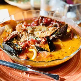 Cioppino - seafood stew of shrimp, scallops, lobster, clams, mussels, calamari, and fish sautéed in a tomato saffron broth