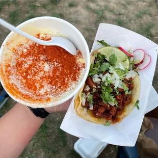 Street corn in a cup and chorizo taco