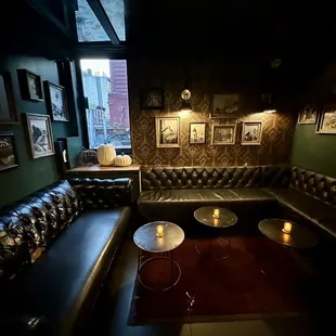 a dimly lit room with leather couches