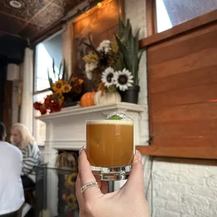 a person holding a drink in their hand