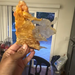 Pizza cooked with paper stuck on it