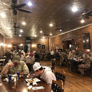a group of soldiers eating in a restaurant