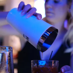 a woman pouring a drink