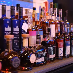 a row of liquor bottles on a bar