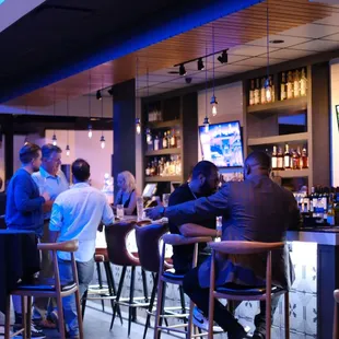 a group of people sitting at a bar