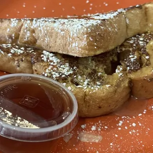 a plate of french toast with syrup