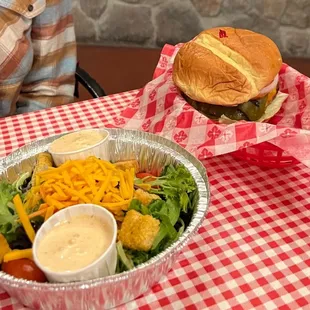 a sandwich and salad on a table