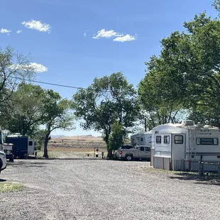 a group of rvs parked on a gravel road