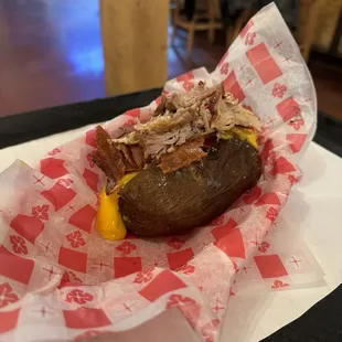 Stuffed baked potato with pulled pork, bacon, butter, sour cream, cheese. It was excellent.