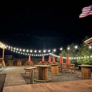 a patio with tables and umbrellas