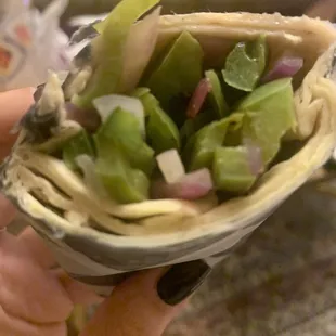 Veggie Wrap in a stale bland wrap filled with raw onions and green peppers. Despicable