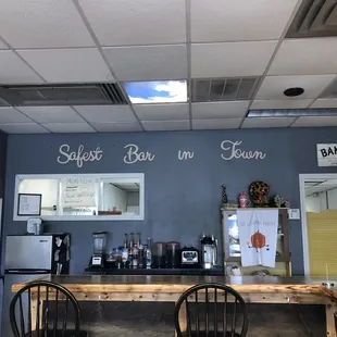 a bar with a counter and chairs