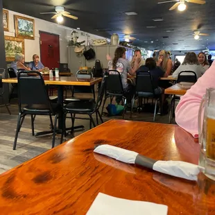 people sitting at tables in a restaurant