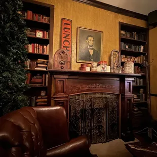 a living room with a fireplace and bookshelves