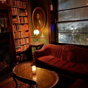 a living room with bookshelves and a fireplace