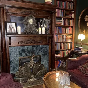 a living room with a fireplace and bookshelves