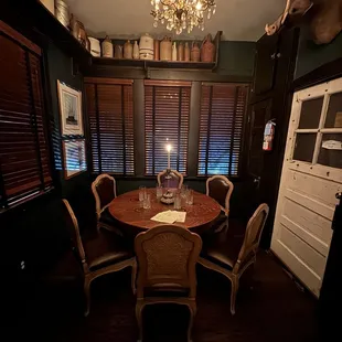 a dining room with a table and chairs