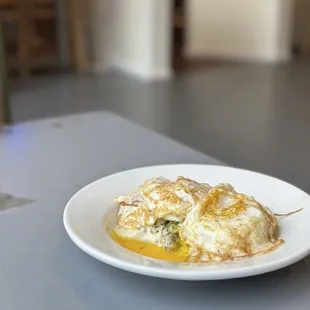 Biscuits &amp; gravy topped with over easy eggs