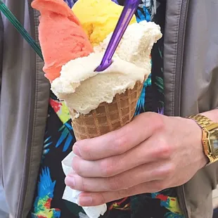 a person holding an ice cream cone