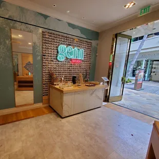 Neon sign on the wall next to the door.