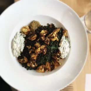 Vegetarian dinner feature: beluga lentils over eggplant purée with sautéed arugula, curried cauliflower, and cilantro yogurt. EXCELLENT!