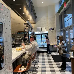 a man sitting at a counter in a restaurant