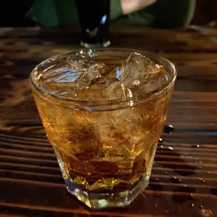 a glass of whiskey on a table