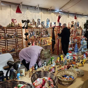 a woman looking at a display of toys