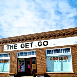 Outside of this small gourmet grocery store.