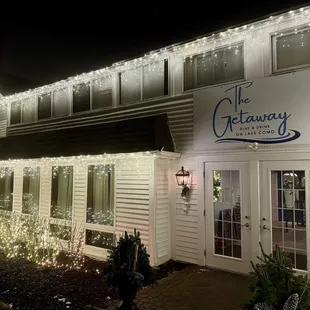 Outside front view of "The Getaway" next to "The French Country Inn." Beautiful outside lights for the holiday season!