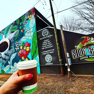 a hand holding a cup of coffee