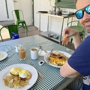 Eggs Benedict, and egg scramble, apple juice, coffee, empty cinnamon roll plate!