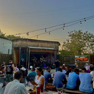a group of people sitting at picnic tables