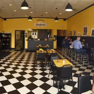 people sitting at tables in a restaurant