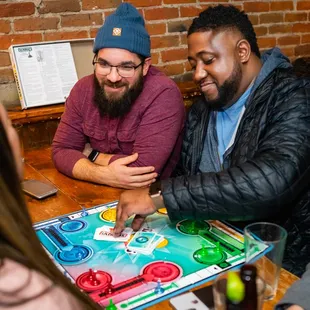 a group of people playing a board game
