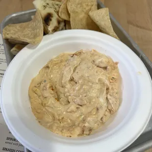 a bowl of dip and chips