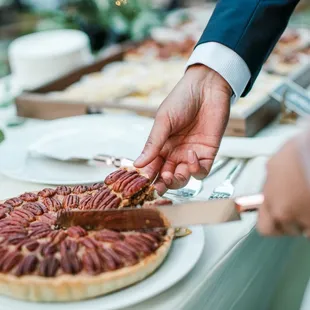 a person cutting a pie
