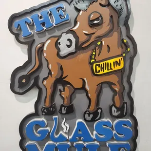 The Glass Mule wooden logo displayed in the shop.