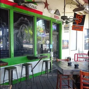 The front door is located on the deck of the restaurant, and you'll note the sports pennants and beer signs, along with the state flag.