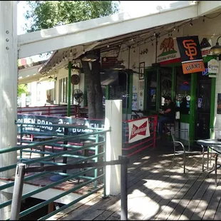 The patio is located in front of the restaurant, on a wooden deck, and offers both tall bar table and chairs, and standard tables and chairs