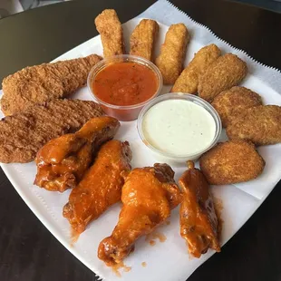 Appetizer sampler. Chicken tenders, mozzarella sticks, fried jalapeños, buffalo chicken wings