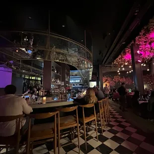 people sitting at a bar in a restaurant