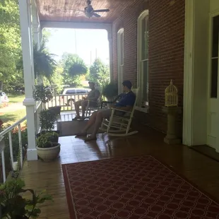 Guests relaxing on the back porch over looking the Kentucky River after lunch &amp; corn hole.