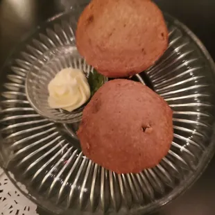 two muffins on a glass plate