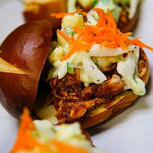 BBQ Chicken Sliders w/ pineapple jalapeno slaw on Pretzel bun