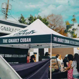 a group of people standing under a tent