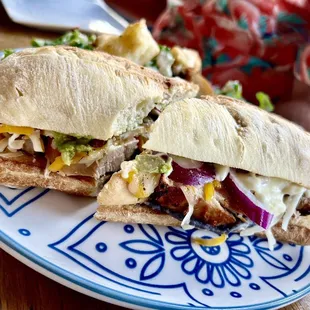 a sandwich on a blue and white plate