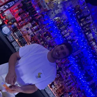 a man standing in front of a bar